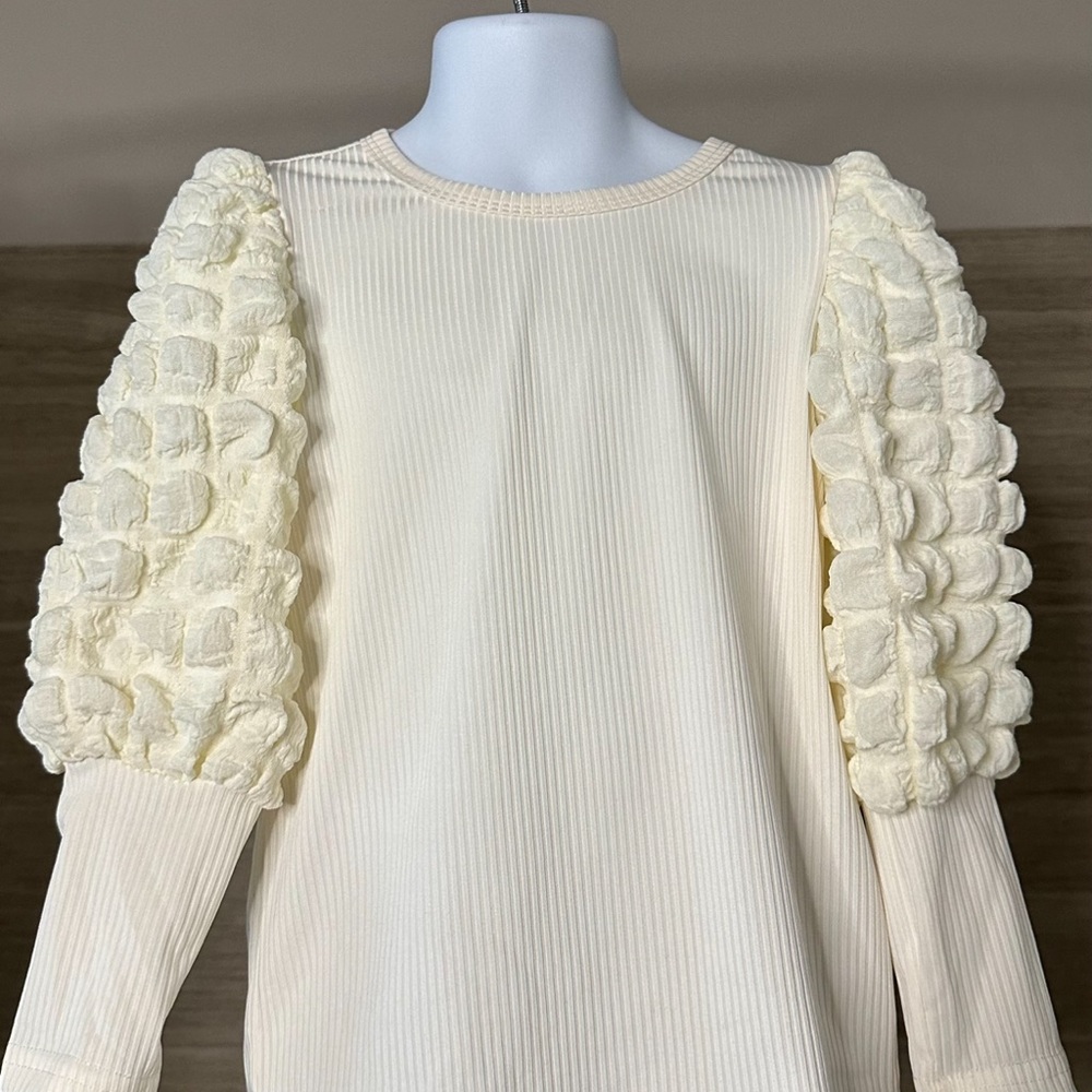 White/beige girls sweater with fantasy on sleeves